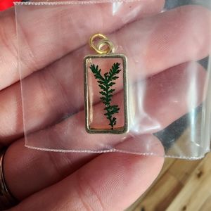 Gold toned pendant with leaf